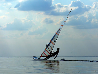 Image showing Silhouette of a wind-surfer on waves of a gulf