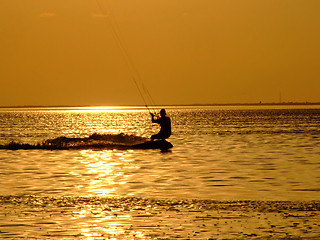 Image showing Silhouette of a kite-surf on waves of a gulf on a sunset 1