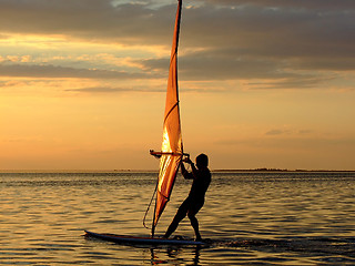Image showing Silhouette of a wind-surfer on waves of a gulf on a sunset 2