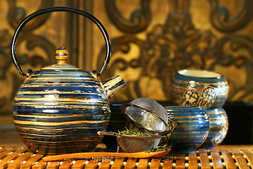 Image showing Blue oriental teapot with cups