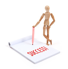 Image showing Wooden mannequin writing - Success