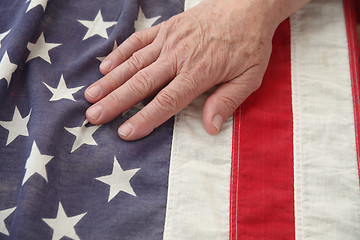 Image showing man with hand on USA flag