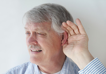 Image showing Mature man has trouble hearing.	