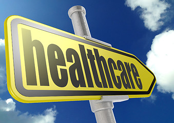 Image showing Yellow road sign with healthcare word under blue sky