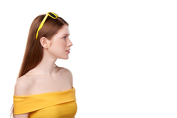 Image showing Redheaded female in yellow top and sunglasses