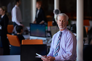 Image showing senior business man with his team at office