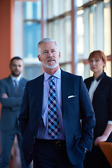 Image showing senior business man with his team at office