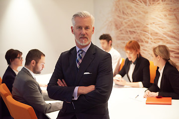 Image showing senior business man with his team at office