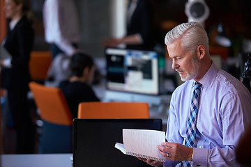 Image showing senior business man with his team at office