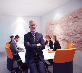 Image showing senior business man with his team at office