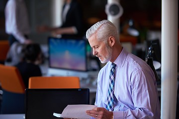 Image showing senior business man with his team at office