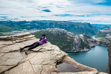 Image showing Prekestolen. Woman looking at the landscape from a height.