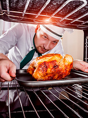 Image showing Cooking chicken in the oven.