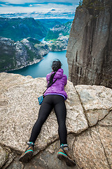 Image showing Prekestolen. Woman looking at the landscape from a height.