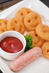 Image showing sausages with smiling potatoes