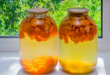 Image showing Home canning: large glass cylinders with apricot compote.