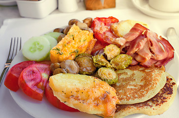 Image showing Meat, fish and various vegetable garnish on a plate.