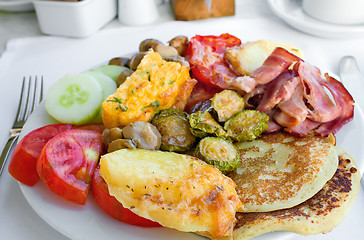 Image showing Meat, fish and various vegetable garnish on a plate.