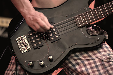 Image showing A musician playing electric guitar on concert