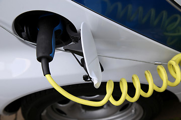 Image showing Electric car being charged at the station, close up of the power