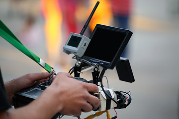 Image showing Operator holding a remote control with helicopter drone