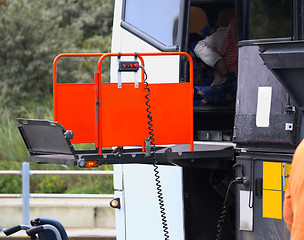 Image showing details of a bus using a chair lift for wheelchair