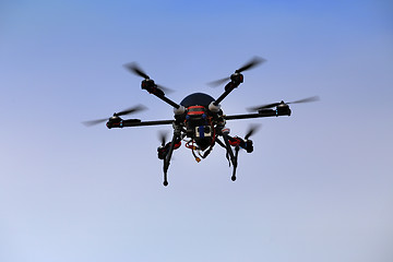 Image showing flying drone with an octocopter for video and photo productions 