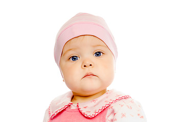 Image showing serious baby in a pink hat on a white background