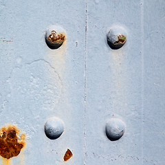 Image showing blue   handle in london antique  door  rusty  brass nail and lig