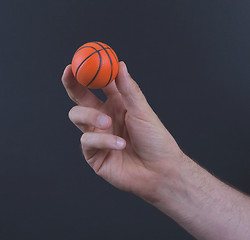 Image showing Isolated hand with a mini basket ball 