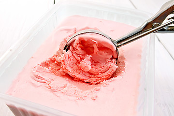Image showing Ice cream strawberry in scoop and tray on board