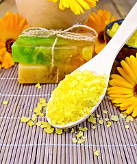 Image showing Salt yellow and soap with calendula on bamboo