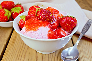 Image showing Ice cream strawberry in white bowl and spoon on board