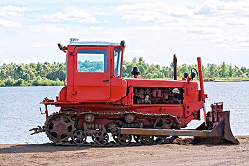 Image showing Bulldozer red by the river