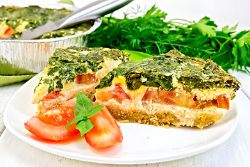 Image showing Pie celtic with spinach and tomato in plate on table