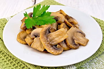 Image showing Champignons fried in plate on light board
