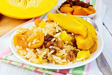 Image showing Pilaf fruit with pumpkin in white plate on board