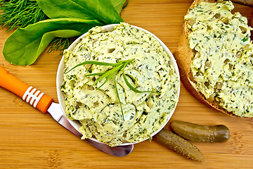 Image showing Butter with spinach and herbs in bowl on board top