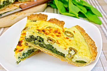 Image showing Pie with spinach in plate on fabric