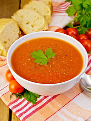 Image showing Soup tomato with bread on napkin and board