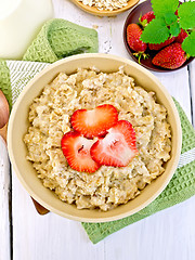 Image showing Oatmeal with strawberry on light board top