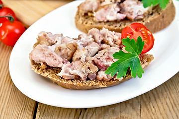 Image showing Sandwich with brains and tomato in plate on board