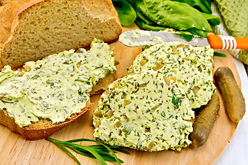 Image showing Butter with spinach and bread on board