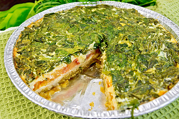 Image showing Pie celtic with spinach and tomatoes in form of foil on board