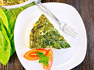 Image showing Pie celtic with spinach and tomato in plate on table top