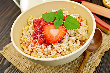 Image showing Oatmeal with strawberry-rhubarb sauce on board