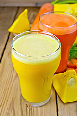 Image showing Juice pumpkin and carrot with vegetables on wooden board