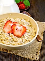 Image showing Oatmeal with strawberry on board