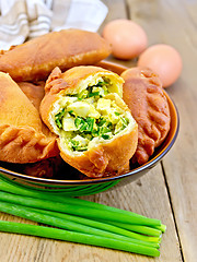 Image showing Patties with onion and egg in bowl on board