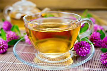 Image showing Tea with clover in cup on bamboo